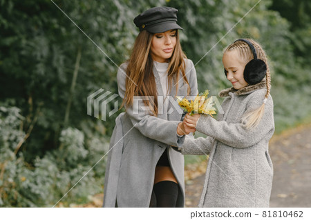 Cute and stylish family in a autumn park 81810462