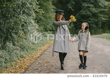 Cute and stylish family in a autumn park 81810470