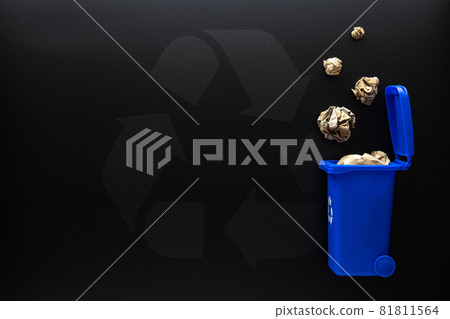 Recycle paper garbage. Blue dustbin for recycle paper trash on black background. Bin container for disposal garbage waste and save environment. Copy space. 81811564