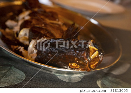 delicious smoked fish on a plate. close-up, selective focus, blurred background delicious smoked fish on a plate. close-up, selective focus, blurred background 81813005