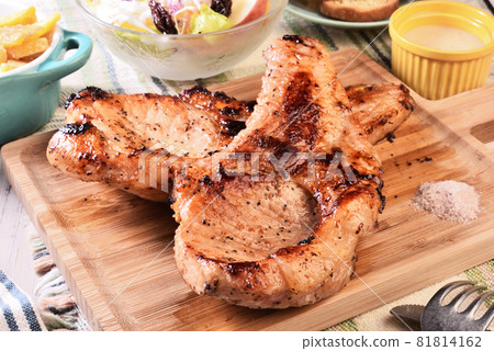 Two grilled tomahawk pork chops Two grilled tomahawk pork chops 81814162
