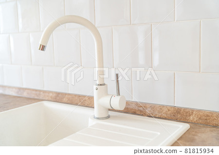 white sink and kitchen faucet. plumbing for home 81815934