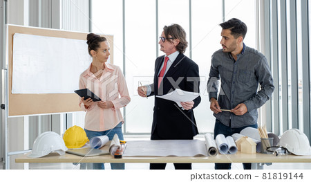 Team of male and female engineers and architects, working team, meeting, discussing construction and drawing construction plans, printing, writing on-site construction sites Team of male and female engineers and architects, working team, meeting, discussing construction and drawing construction plans, printing, writing on-site construction sites 81819144