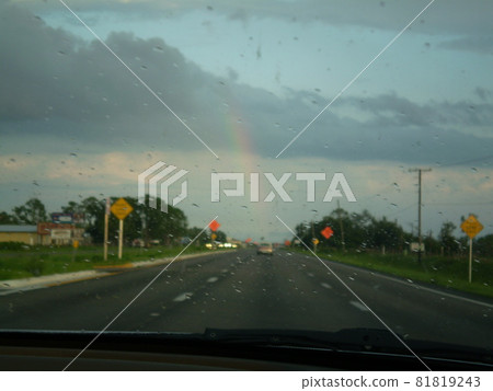 A rainbow that appeared after heavy rain while driving A rainbow that appeared after heavy rain while driving 81819243