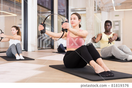 Young sporty woman exercising with pilates circle Young sporty woman exercising with pilates circle 81819376