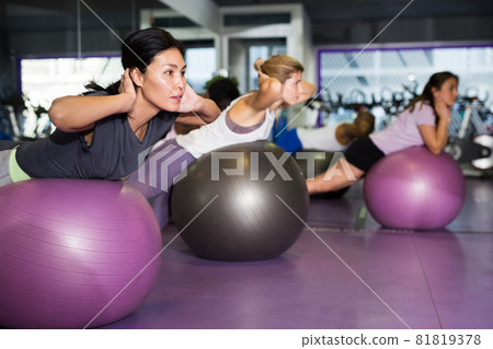 Sporty woman doing exercises with fit ball Sporty woman doing exercises with fit ball 81819378