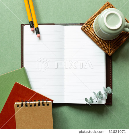 Open notebook, coffee cup, pencil on green background. top view, copy space. workspace, study concept Open notebook, coffee cup, pencil on green background. top view, copy space. workspace, study concept 81821071