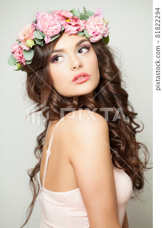 Beautiful model woman in flowers crown. Woman spring makeup portrait Beautiful model woman in flowers crown. Woman spring makeup portrait 81822294