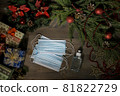 Christmas decoration with mask and sanitizer on wood table 81822729