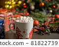 Christmas drink. Cup of hot chocolate with marshmallows and gifts on festive background 81822739