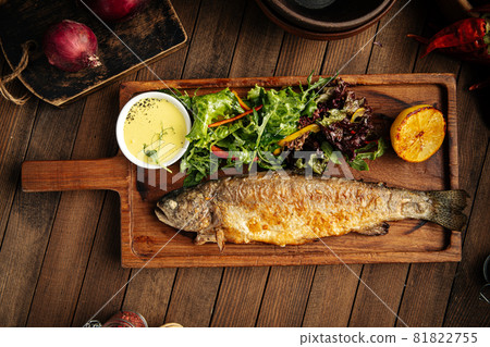 Homemade fried trout fish with sauce and salad Homemade fried trout fish with sauce and salad 81822755