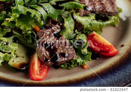 Salad with warm veal and greens Salad with warm veal and greens 81822847