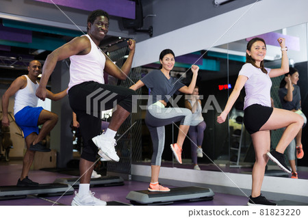 People training on step platforms in gym People training on step platforms in gym 81823220