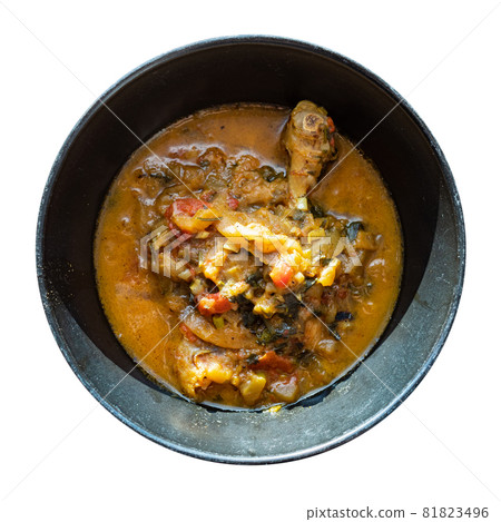 top view of Chakhokhbili (traditional georgian dish from stewed chicken meat, tomato, eggplant and fresh herbs) in black bowl cutout on white background top view of Chakhokhbili (traditional georgian dish from stewed chicken meat, tomato, eggplant and fresh herbs) in black bowl cutout on white background 81823496