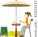 A woman relaxing at an open cafe 81824197