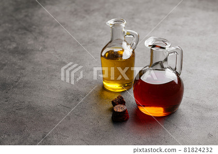 Side view on two lass jugs with oil for cooking Side view on two lass jugs with oil for cooking 81824232