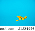 Yellow pills on blue background 81824956