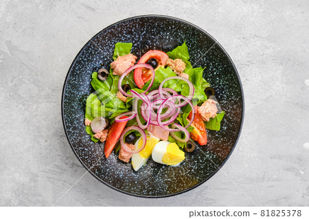 Top view of salad with lettuce, salmon, tomato, boiled egg and onion Top view of salad with lettuce, salmon, tomato, boiled egg and onion 81825378