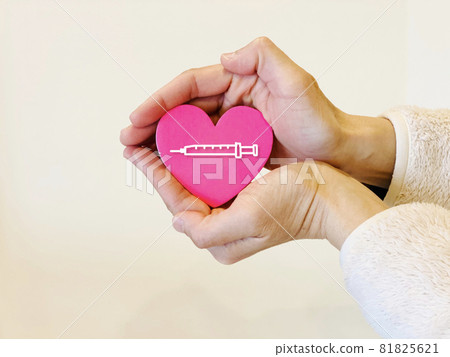 Female hand wrapping the heart with both hands_Syringe illustration included 81825621