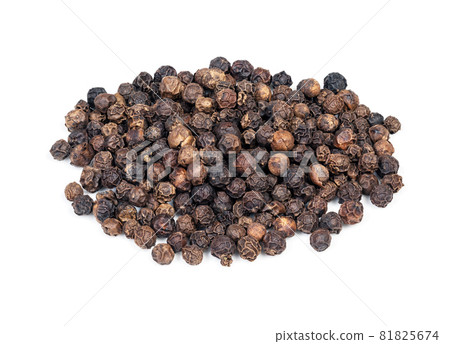 handful of hainan black pepper closeup on white background 81825674