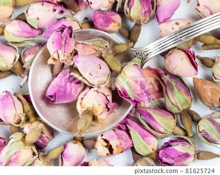 top view of silver spoon on pile of dried rose buds closeup top view of silver spoon on pile of dried rose buds closeup 81825724