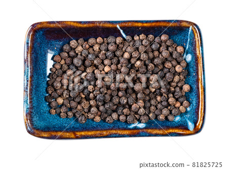top view of hainan black pepper on rectangular plate cutout on white background top view of hainan black pepper on rectangular plate cutout on white background 81825725