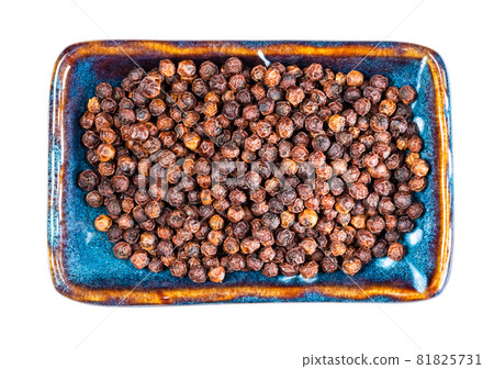 top view of dried red Kampot pepper on rectangular plate cutout on white background top view of dried red Kampot pepper on rectangular plate cutout on white background 81825731
