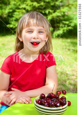 Child eating wild cherry Child eating wild cherry 81825988