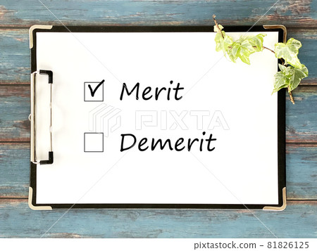 White paper sandwiched between clipboards_blue wood board background_horizontal_with Merit and Demerit characters White paper sandwiched between clipboards_blue wood board background_horizontal_with Merit and Demerit characters 81826125