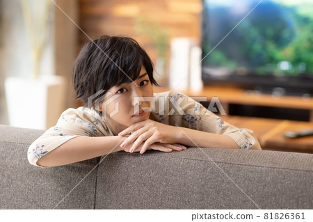 A beautiful woman relaxing in the living room A beautiful woman relaxing in the living room 81826361