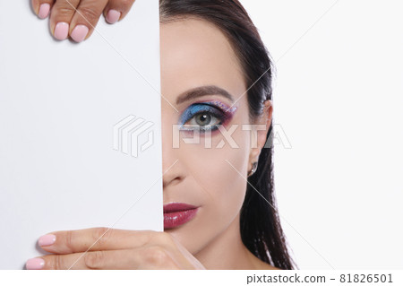 Half face of young sexy woman with burgundy lipstick and bright eye makeup closeup Half face of young sexy woman with burgundy lipstick and bright eye makeup closeup 81826501
