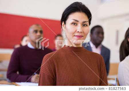 Woman in group of students in university audience 81827563
