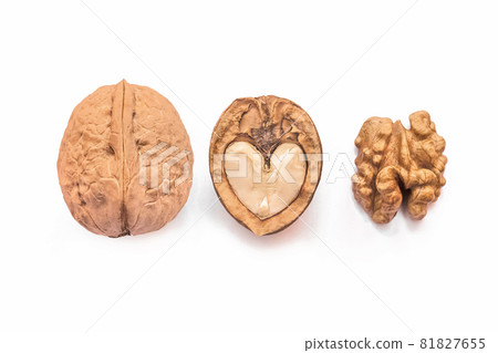 Different forms and areas of walnut. Walnut half in the form of a heart and peeled nut on a white background, isolated 81827655