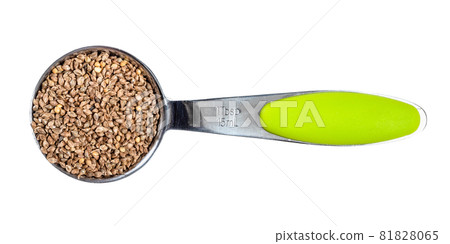 top view of unhulled barnyard millet seeds in measuring tablespoon cutout on white background 81828065
