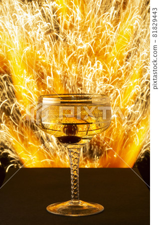 New Year and Christmas image of champagne glass on blast of sparks background New Year and Christmas image of champagne glass on blast of sparks background 81829443