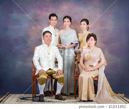 Happy couple hold hand together in their wedding day with pride's family Happy couple hold hand together in their wedding day with pride's family 81831892