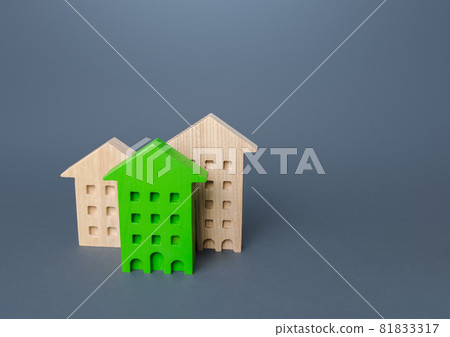 Green residential building among houses. Environmentally friendly, energy efficient. Renovation and improvement of old buildings. Search for best option to buy. Net Zero Carbon neutrality. 81833317
