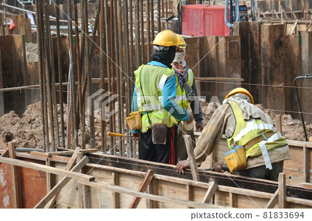 MALACCA, MALAYSIA -MAY 25, 2016: Construction workers fabricating timber form work at the construction site in Malacca, Malaysia. The form work was mainly made from timber and plywood.  81833694