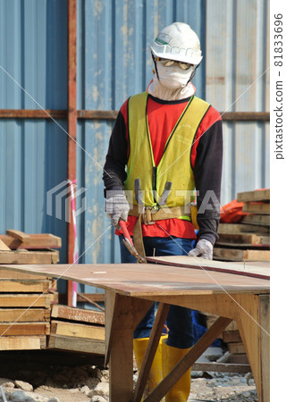 MALACCA, MALAYSIA -MAY 25, 2016: Construction workers fabricating timber form work at the construction site in Malacca, Malaysia. The form work was mainly made from timber and plywood. MALACCA, MALAYSIA -MAY 25, 2016: Construction workers fabricating timber form work at the construction site in Malacca, Malaysia. The form work was mainly made from timber and plywood. 81833696