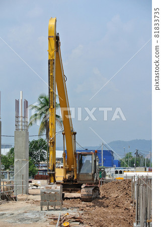 SELANGOR, MALAYSIA -APRIL 25, 2016: Excavators machine is heavy construction machine used excavate soil at the construction. Powered by long hydraulic arm with bucket. Handle by workers. SELANGOR, MALAYSIA -APRIL 25, 2016: Excavators machine is heavy construction machine used excavate soil at the construction. Powered by long hydraulic arm with bucket. Handle by workers. 81833735