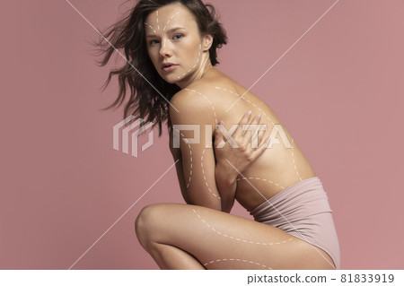 Perfect slim tanned young girl or fit woman at studio. The fitness, diet, sports, plastic surgery, natural beauty concept. Arrows, drawings on body Perfect slim tanned young girl or fit woman at studio. The fitness, diet, sports, plastic surgery, natural beauty concept. Arrows, drawings on body 81833919
