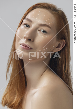 Close-up portrait of young, beautiful and healthy woman with arrows on her face. The spa, surgery, face lifting and skin care concept Close-up portrait of young, beautiful and healthy woman with arrows on her face. The spa, surgery, face lifting and skin care concept 81833941