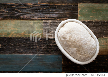 Bread dough in a rattan basket on a table made of wood Bread dough in a rattan basket on a table made of wood 81835461