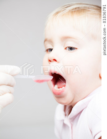 Doctor gives cough medicine to a child Doctor gives cough medicine to a child 81836791