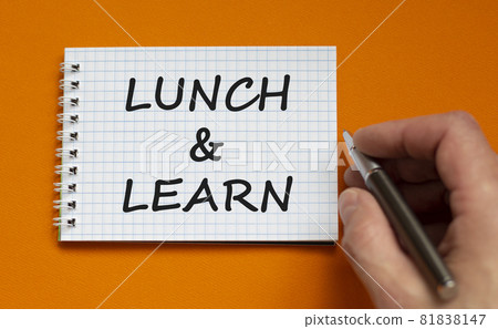 Lunch and learn symbol. Businessman writing words 'Lunch and learn' on white note. Beautiful orange background. Business, educational and lunch and learn concept. Copy space. 81838147