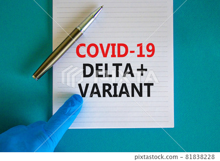 Covid-19 delta plus variant strain symbol. Hand in blue glove with white card. Concept words Covid-19 delta plus variant. Metalic pen. Medical, COVID-19 delta plus variant strain concept. Copy space. 81838228