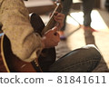 Playing an acoustic guitar in a guitar classroom 81841611