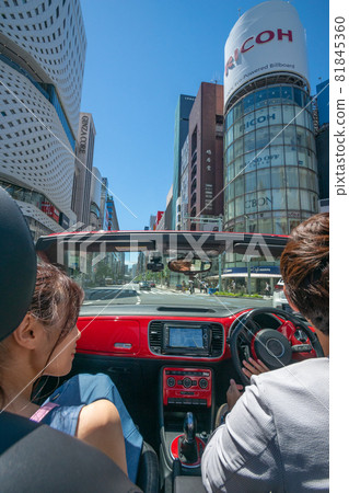 A couple dating the middle of the city in an open car A couple dating the middle of the city in an open car 81845360