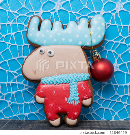 minimal christmas concept, gingerbread or cookies in the form of a fairy moose on a blue background, horns on a hanging christmas decoration, holiday minimal christmas concept, gingerbread or cookies in the form of a fairy moose on a blue background, horns on a hanging christmas decoration, holiday 81846459