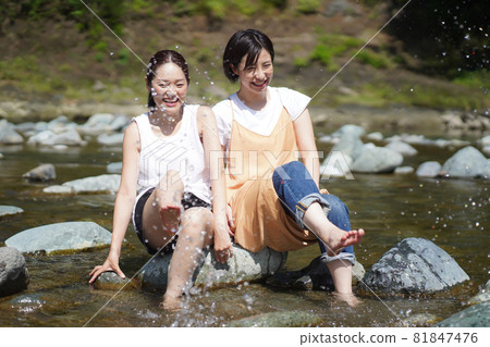 Women playing on the river Women playing on the river 81847476